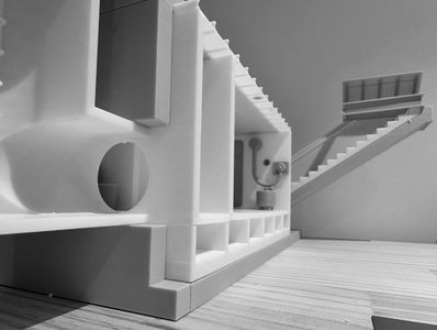 Close-up of a detailed architectural model with staircases and compartments.