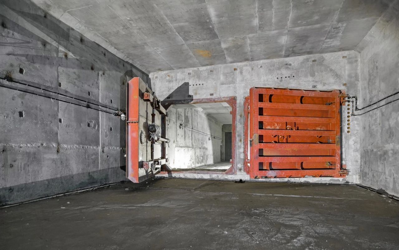 Open heavy doors in an abandoned concrete bunker. Illustrative Envato photograph.