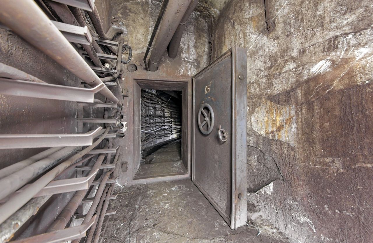 A Cold War-era bunker corridor with a heavy steel door and pipes. Illustrative stock photograph, not Object 1335. saoirse2010 / Envato.